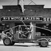 An auto polo vehicle in front of Jim Schocke's R & S Motor Sales, Inc.
